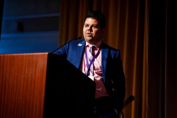 Professor Michael Sinha Speaks at the Podium